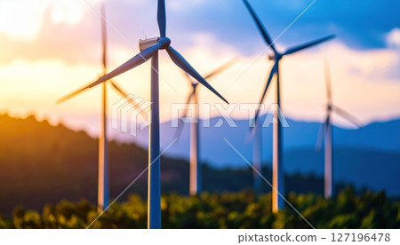 Renewable wind turbine power generation in a green energy farm at sunset Renewable wind turbine power generation in a green energy farm at sunset 127196478