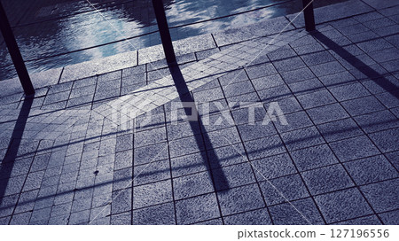 Shadows cast by the setting sun and the cobblestone sidewalk Shadows cast by the setting sun and the cobblestone sidewalk 127196556