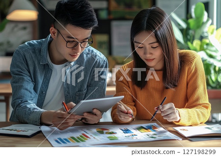 Colleagues Collaborate on a Business Plan in an Innovative Workspace. Generative AI 127198299