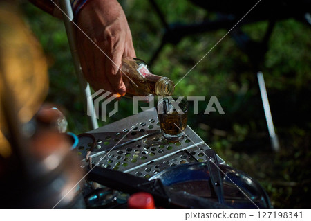 Solo camper drinking alcohol, solo camping, senior Solo camper drinking alcohol, solo camping, senior 127198341