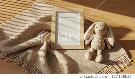 a toy hare and a blockbuster on a bed with a window shade a toy hare and a blockbuster on a bed with a window shade 127198625