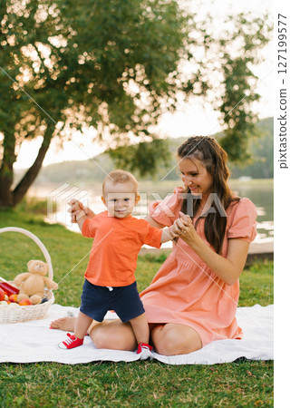 Baby Holding Mom Hands At Picnic Baby Holding Mom Hands At Picnic 127199577