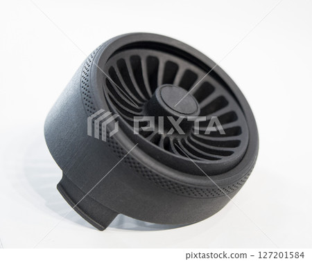 Object printed on 3D printer from melted black plastic on white isolated background. Plastic grid of round shape created on 3D printer. Small form printed by 3D printer Additive 3d printing technology 127201584