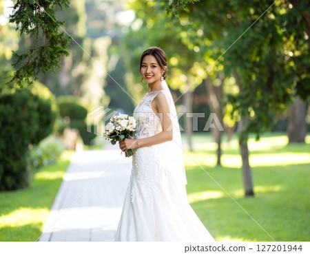 Portrait of a happy bride holding a bouquet Portrait of a happy bride holding a bouquet 127201944