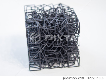 Object printed on 3D printer from melted black plastic on white isolated background. Plastic mesh cube shape created on 3D printer. Small form printed by 3D printer Additive 3d printing technology Object printed on 3D printer from melted black plastic on white isolated background. Plastic mesh cube shape created on 3D printer. Small form printed by 3D printer Additive 3d printing technology 127202116