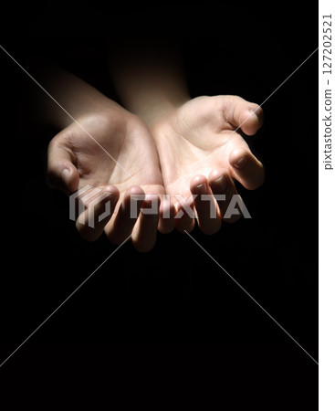 Asking hands on black backdrop Asking hands on black backdrop 127202521