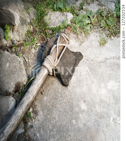 Stone ax of a primitive man Stone ax of a primitive man 127202534