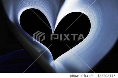 Book pages folded in the shape of a heart 127202547