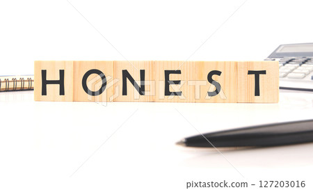 The concept word HONEST is assembled from cubes. Business integrity ethics honesty respect concept 127203016
