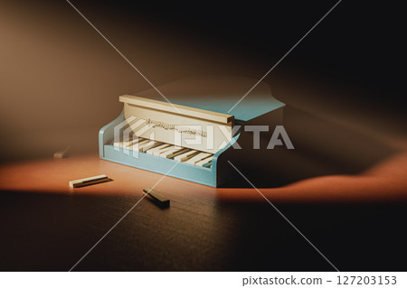 Small blue piano with a keyboard and a few wooden blocks on the table 127203153