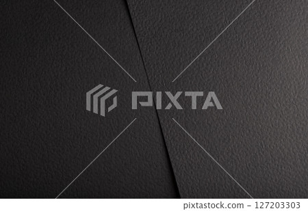 Black matte paper texture with a premium, elegant finish, featuring an abstract, geometric design. Black matte paper texture with a premium, elegant finish, featuring an abstract, geometric design. 127203303