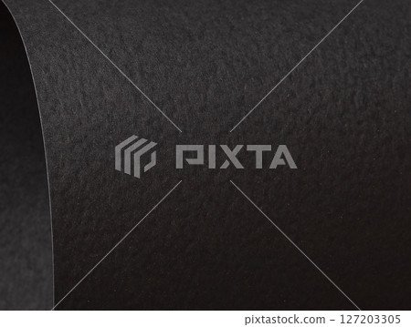 Black matte paper texture with a premium, sleek finish, creating a rich, minimalistic backdrop. 127203305