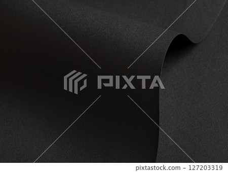 Black velvet-textured paper with a matte finish, featuring smooth, wavy folds and edges. Premium, 127203319