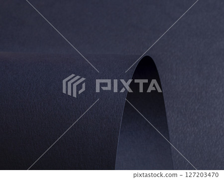 Premium dark blue designer paper with a matte finish. Wavy edges and rolled folds create an abstract Premium dark blue designer paper with a matte finish. Wavy edges and rolled folds create an abstract 127203470