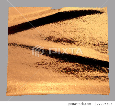 Torn, rippled copper foil texture with a holographic, glossy finish. Frayed, damaged edges creating 127203507