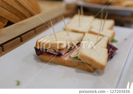 Sandwich toothpicks plate reuben sandwich with pastrami and swiss cheese isolated on white background 127203836