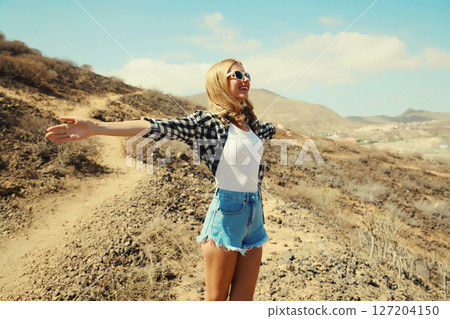Happy cheerful young woman on hiking trail on top of the mountain, Tenerife, Canary Islands, Spain 127204150