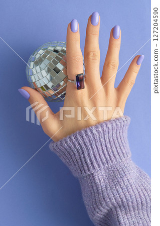Womans hand with fashionable purple manicure. Spring nail design Womans hand with fashionable purple manicure. Spring nail design 127204590