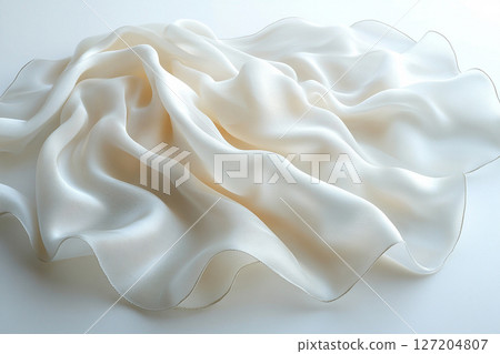 Elegant silk scarf with soft, flowing folds, highlighting its luxurious texture against a simple white background. Elegant silk scarf with soft, flowing folds, highlighting its luxurious texture against a simple white background. 127204807