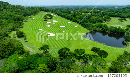 Aerial top view golf course with lush greens, green fairway and sand bunker, Golf course green grass and trees fairway and putting green, Beautiful golf course. Aerial top view golf course with lush greens, green fairway and sand bunker, Golf course green grass and trees fairway and putting green, Beautiful golf course. 127205105