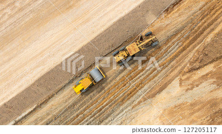 Aerial view motor grader civil at construction site, Motor grader work on construction site, Road grader on road construction site machine work on the construction of new road. 127205117