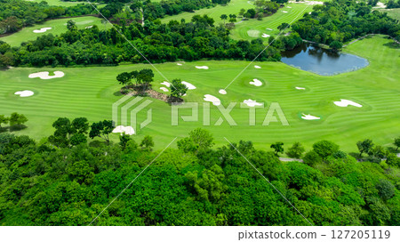 Aerial top view golf course with lush greens, green fairway and sand bunker, Golf course green grass and trees fairway and putting green, Beautiful golf course. Aerial top view golf course with lush greens, green fairway and sand bunker, Golf course green grass and trees fairway and putting green, Beautiful golf course. 127205119