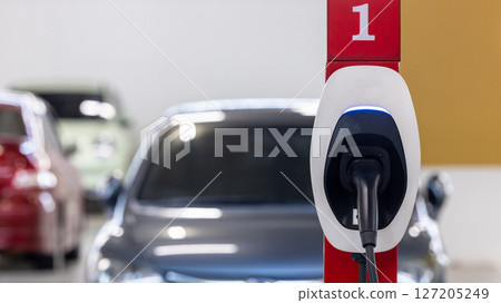 EV charging station electric car, Electric car charging station for charge EV battery, Plug for vehicle with electric engine, EV charger clean energy, Charging point at car parking lot. 127205249