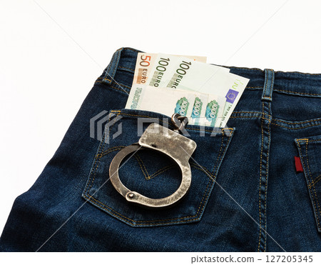In jeans pocket money and handcuffs are euro banknotes and rubles In jeans pocket money and handcuffs are euro banknotes and rubles 127205345