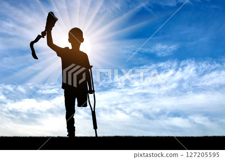Silhouette of Child with Crutches and Prosthetic Limb 127205595
