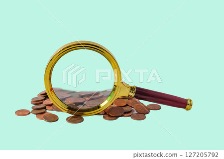 Magnifying glass over coins on background. Magnifying glass over coins on background. 127205792