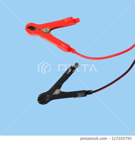 Red and black car battery jumper cables on background. Red and black car battery jumper cables on background. 127205793