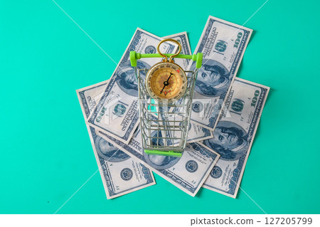 Shopping cart on banknote ,Concept of economy. Shopping cart on banknote ,Concept of economy. 127205799