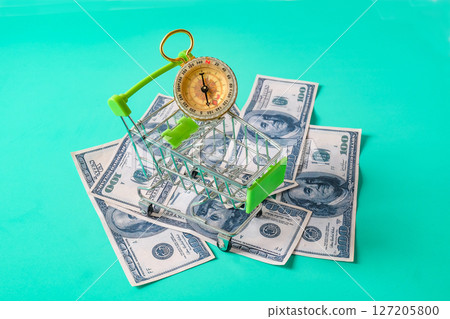 Shopping cart on banknote ,Concept of economy. Shopping cart on banknote ,Concept of economy. 127205800