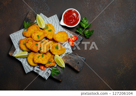Crispy Fried Chicken Nuggets with Tomato Sauce on Dark Background Selective Focus Copy space 127206104