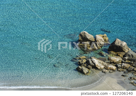 Clear and clear turquoise water on the beach with small stones Clear and clear turquoise water on the beach with small stones 127206140