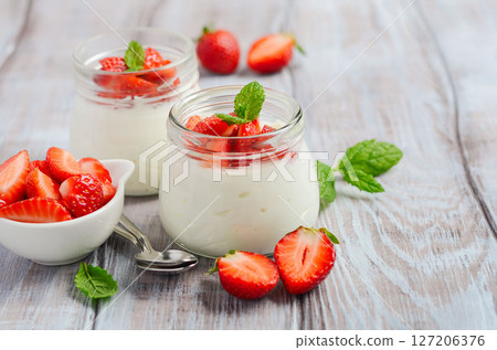 Homemade natural yogurt with strawberries and mint, selective focus. Homemade natural yogurt with strawberries and mint, selective focus. 127206376
