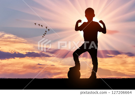 Young Athlete with Foot on Ball at Sunset Young Athlete with Foot on Ball at Sunset 127206664