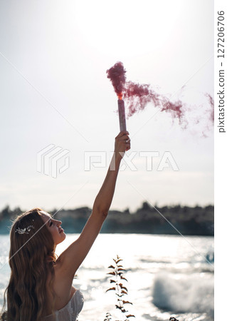 Bride with a pink smoke bomb. Bride with a pink smoke bomb. 127206706