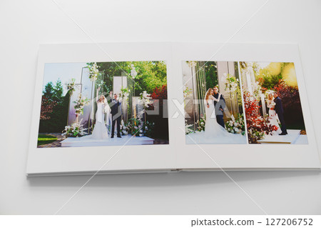 the pages of a photo book with wedding photos.  127206752