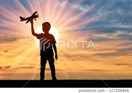 Boy Playing with Toy Airplane at Sunset 127206868