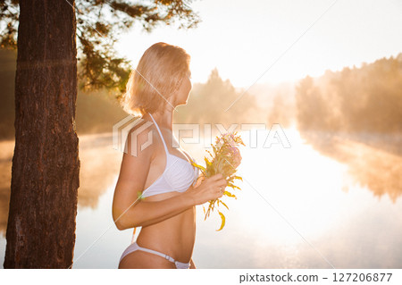 Young woman as silhouette by the sea Young woman as silhouette by the sea 127206877