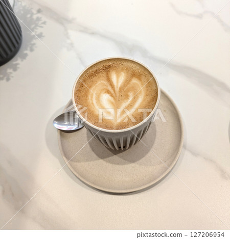 Close Up of an Oat Milk Latte Coffee in White Cup with Love Heart Close Up of an Oat Milk Latte Coffee in White Cup with Love Heart 127206954