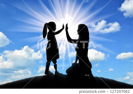 The child is a disabled girl with a prosthetic leg with her mother on the hill 127207062