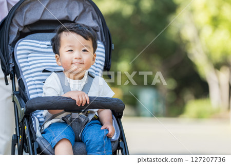 A boy in a stroller. A boy in a stroller. 127207736