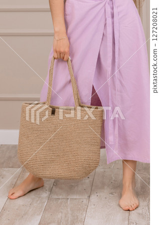 Summer outfit with straw hat and jute bag, perfect for vacation, beach or boho fashion shoots. 127208021