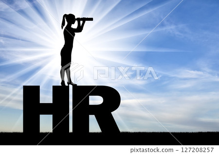 A silhouette of a woman standing on the letters HR and looking through binoculars looking for potential employees 127208257