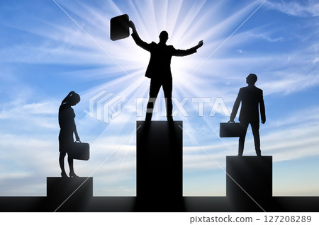 Silhouette of a jubilant man on the podium of a winner and a silhouette of a sad man and woman near 127208289