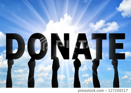 Altruism. Hands of people are holding letters Donate 127208317