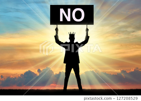 Selfishness. Selfish man with a crown on his head, holding a poster with the word no. 127208529