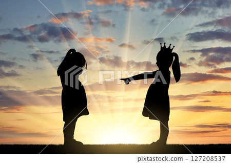 Girl points finger at another crying girl. The concept of bullying among children and at school 127208537